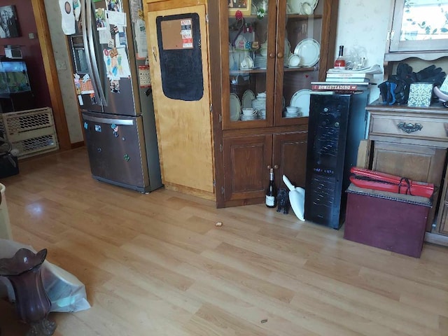 interior space featuring stainless steel fridge and light hardwood / wood-style flooring