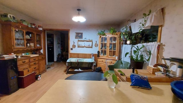 60 Elm St, East Millinocket, ME 04430 - dining area with light wood-style flooring and wainscoting