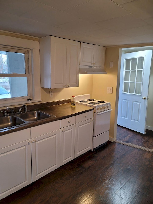 kitchen with under cabinet range hood, white cabinets, white electric stove, and a sink