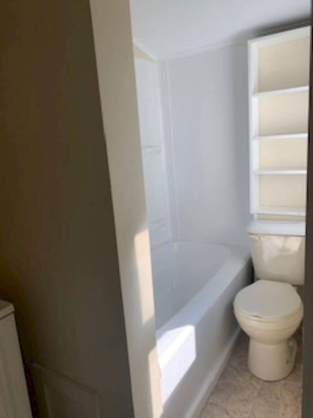 bathroom featuring a shower, toilet, and a washtub