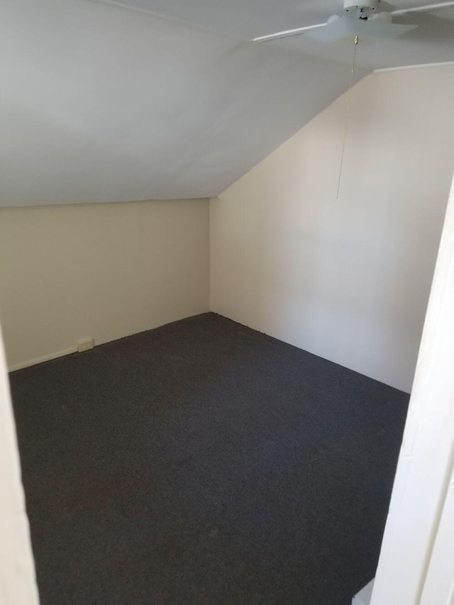 additional living space with carpet flooring, a ceiling fan, and lofted ceiling