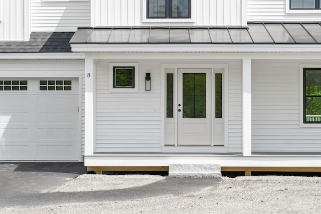 view of exterior entry with a garage