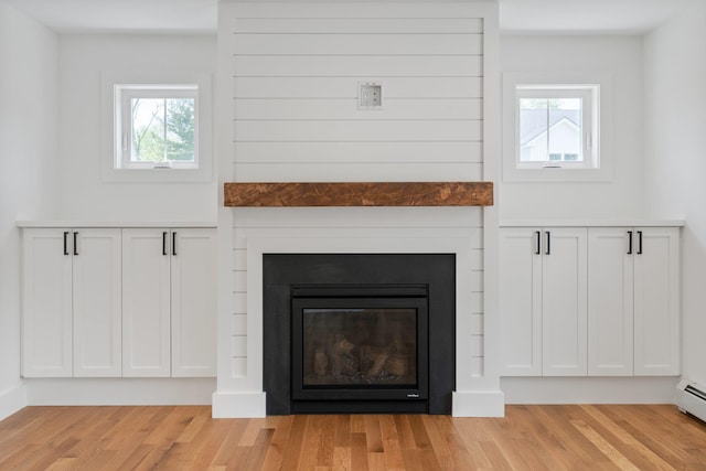 761 Fort Hill Rd, Gorham, ME 04038 - details featuring a glass covered fireplace and wood finished floors