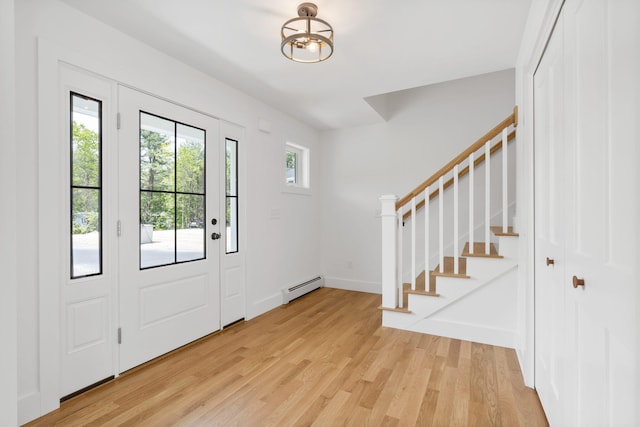 761 Fort Hill Rd, Gorham, ME 04038 - entryway with an inviting chandelier, light wood-style flooring, stairs, a baseboard radiator, and baseboards