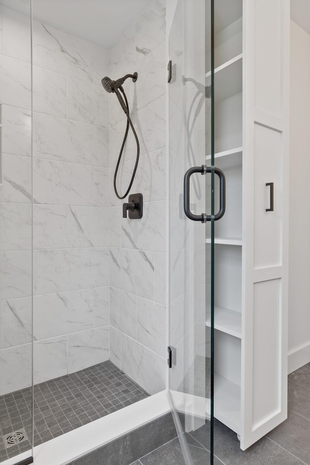 bathroom featuring a shower with door and tile patterned floors