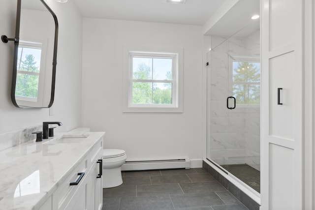 bathroom featuring vanity, an enclosed shower, toilet, a baseboard heating unit, and tile patterned floors