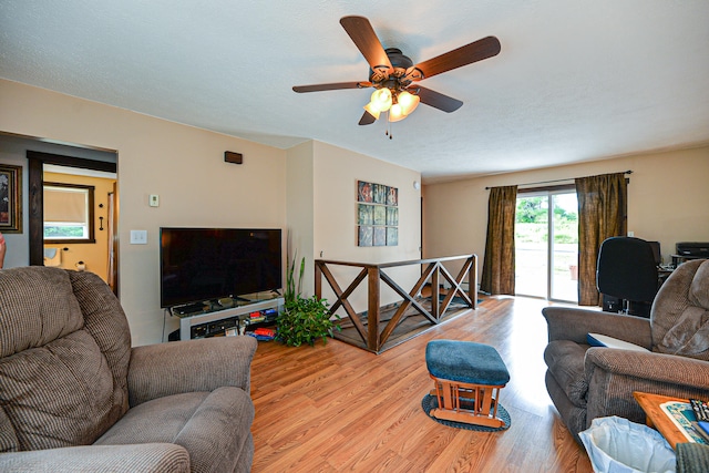 living room featuring light hardwood / wood-style floors and ceiling fan