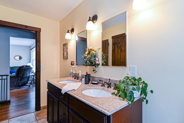 bathroom featuring vanity, a textured ceiling, and hardwood / wood-style floors