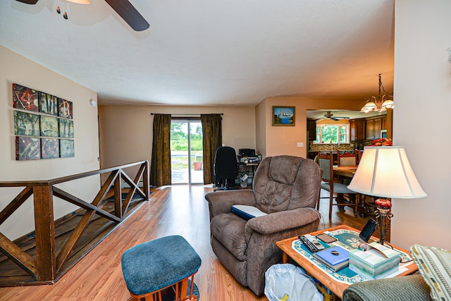 832 College St, Lewiston, ME 04240 - living area featuring ceiling fan, light wood-type flooring, and a chandelier