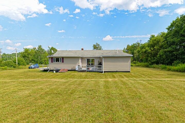 back of house featuring a deck and a yard