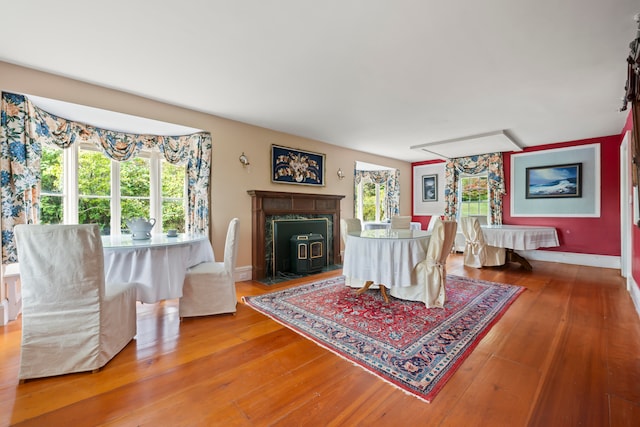 interior space with a wealth of natural light, a premium fireplace, and hardwood / wood-style floors