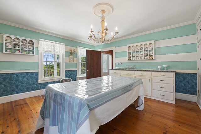 bedroom with ornamental molding and hardwood / wood-style flooring