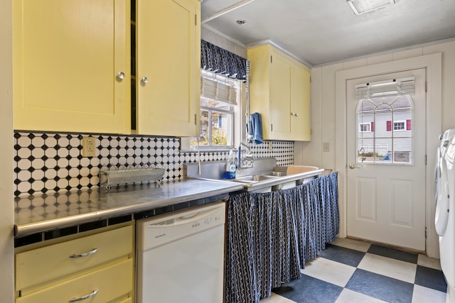 kitchen with sink, dishwasher, tile counters, washer and dryer, and decorative backsplash