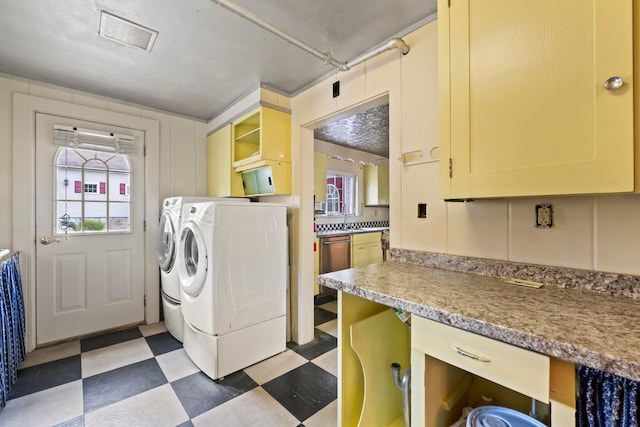 laundry room with separate washer and dryer and a wealth of natural light