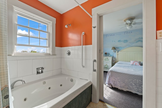 bathroom featuring tiled tub and ceiling fan