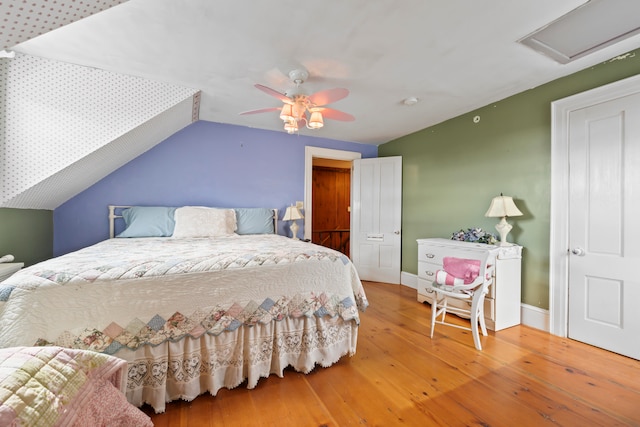 bedroom featuring lofted ceiling, ceiling fan, and hardwood / wood-style flooring