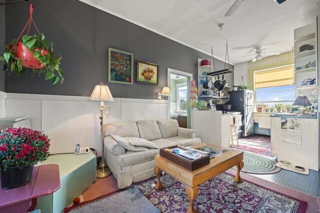 living room featuring ceiling fan and hardwood / wood-style flooring