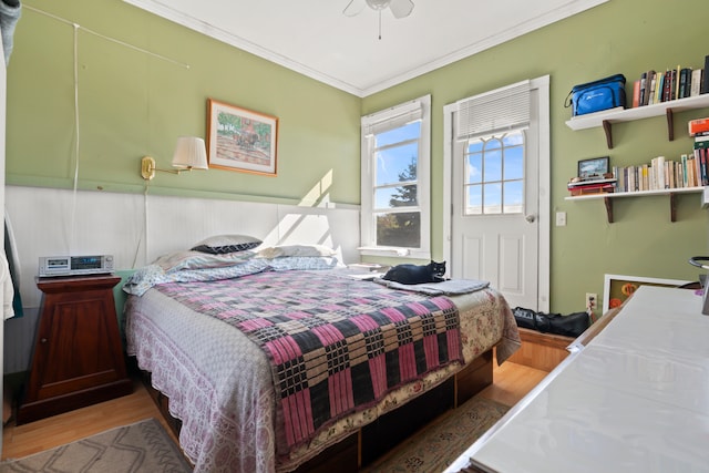 bedroom featuring crown molding, hardwood / wood-style floors, and ceiling fan