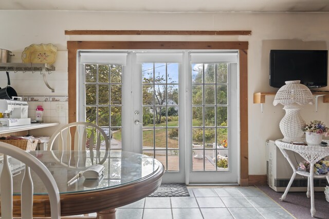 doorway to outside with light tile patterned floors