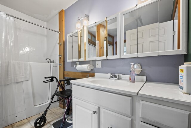 bathroom featuring vanity, tile patterned flooring, and shower / bathtub combination with curtain