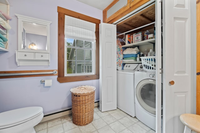 laundry room featuring baseboard heating and washing machine and dryer