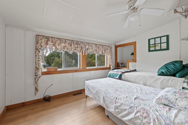 bedroom with light wood-type flooring, lofted ceiling, and ceiling fan