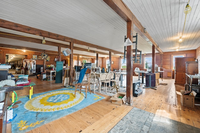 misc room featuring wood walls and light hardwood / wood-style floors