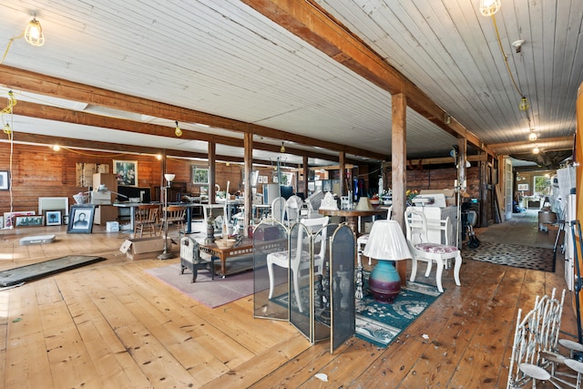 unfurnished dining area with wooden walls, hardwood / wood-style floors, and wood ceiling