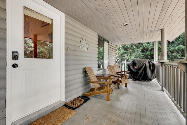 wooden terrace with grilling area and covered porch