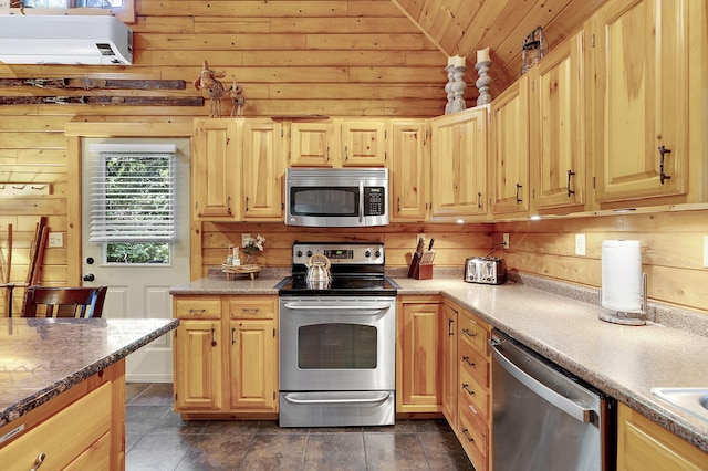 kitchen with light brown cabinetry, stainless steel appliances, vaulted ceiling, wooden walls, and wooden ceiling