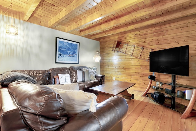 living room with wooden walls, light hardwood / wood-style flooring, beamed ceiling, and wooden ceiling