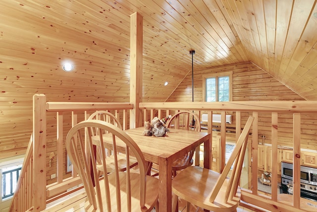 interior space with wooden walls, vaulted ceiling, and wooden ceiling