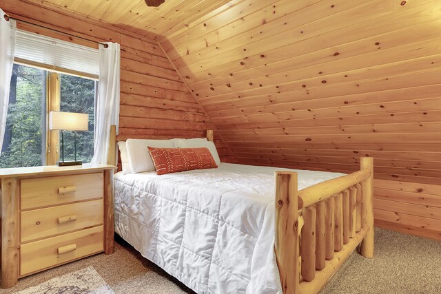 carpeted bedroom featuring wooden ceiling, wooden walls, and vaulted ceiling