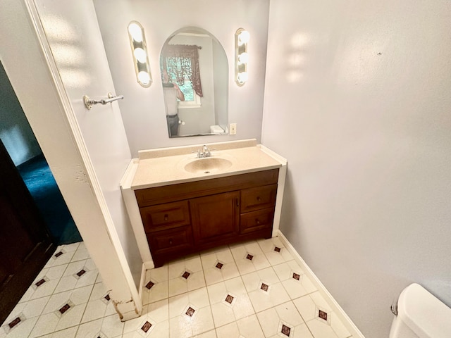 bathroom with tile patterned floors, vanity, and toilet