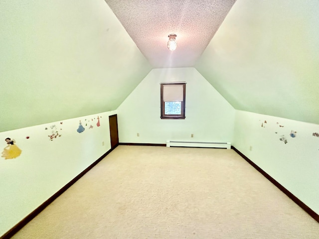 additional living space featuring light colored carpet, a textured ceiling, a baseboard radiator, and vaulted ceiling