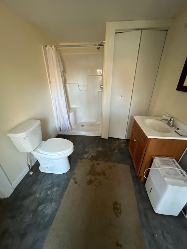 bathroom with walk in shower, vanity, and toilet