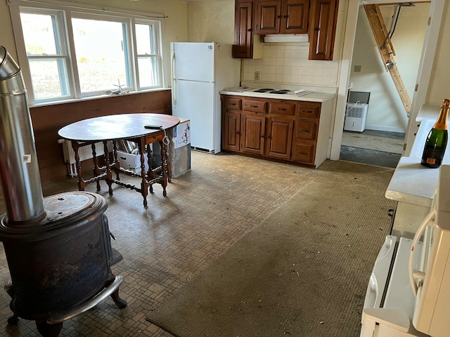 kitchen with white appliances and decorative backsplash