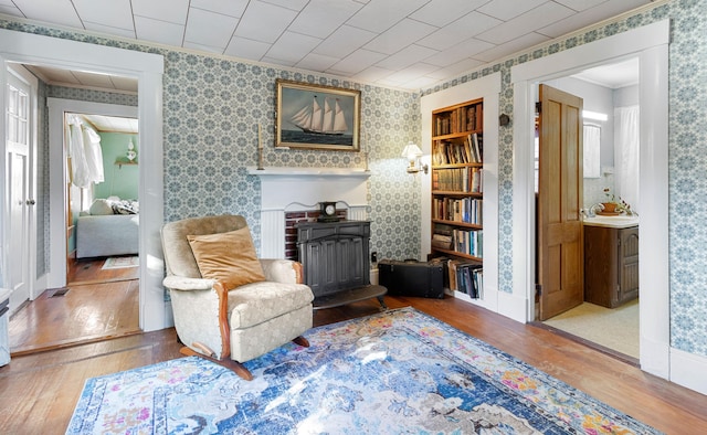 1276 State Route 32, Bristol, ME 04564 - living area with visible vents, baseboards, ornamental molding, wallpapered walls, and wood-type flooring