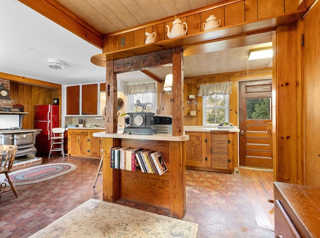 1276 State Route 32, Bristol, ME 04564 - kitchen featuring wooden walls, wooden ceiling, freestanding refrigerator, and brick patterned floor
