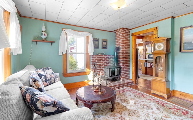 1276 State Route 32, Bristol, ME 04564 - living area with a wood stove, baseboards, ornamental molding, and wood finished floors