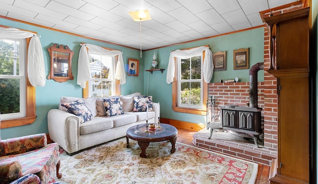 1276 State Route 32, Bristol, ME 04564 - living area featuring crown molding, a wood stove, and plenty of natural light