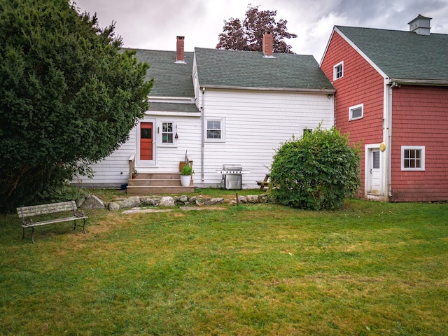1276 State Route 32, Bristol, ME 04564 - back of house featuring a shingled roof, a lawn, and a chimney