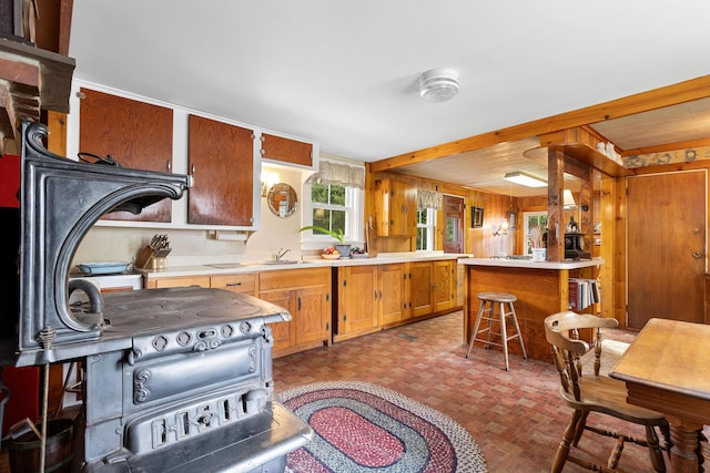 1276 State Route 32, Bristol, ME 04564 - kitchen with brown cabinetry, light countertops, a breakfast bar, and a peninsula