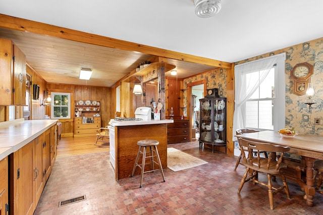1276 State Route 32, Bristol, ME 04564 - kitchen featuring wallpapered walls, light countertops, visible vents, and a breakfast bar