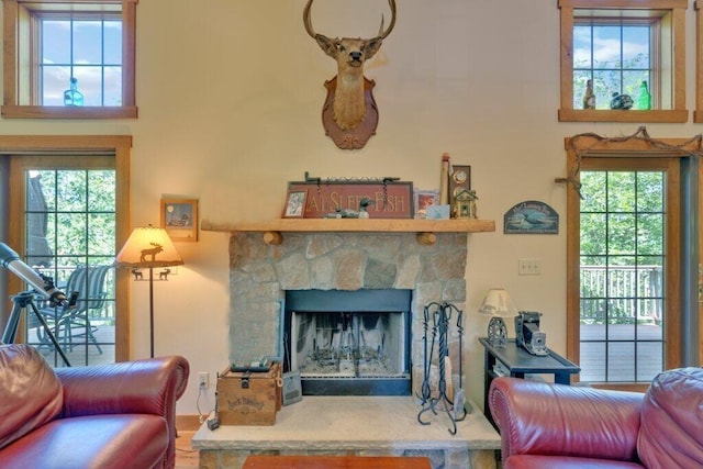 living room with a fireplace and a wealth of natural light