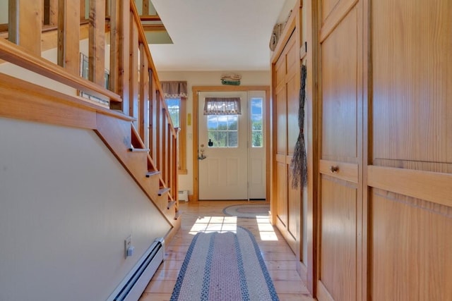 entryway with a baseboard radiator and light tile patterned floors