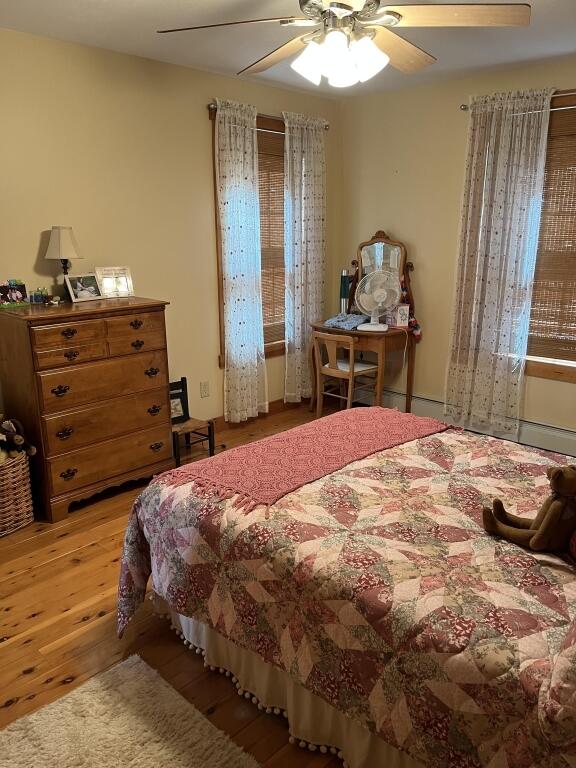 bedroom with ceiling fan and light hardwood / wood-style flooring