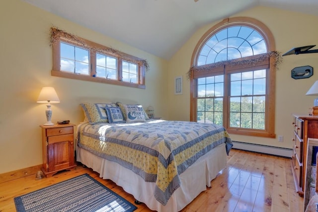 bedroom with lofted ceiling, a baseboard heating unit, light hardwood / wood-style floors, and multiple windows