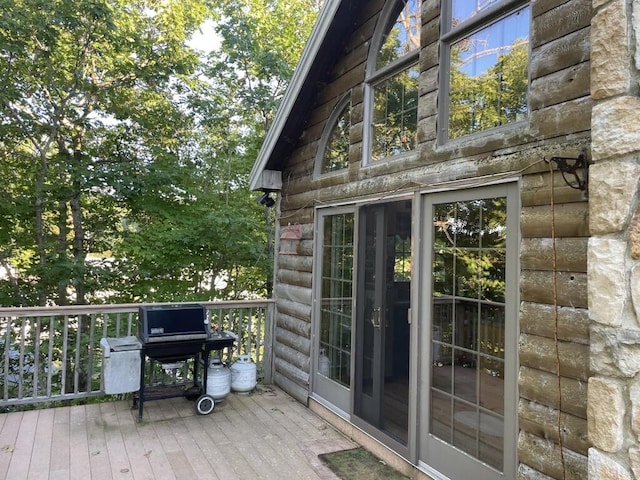 wooden deck with a grill