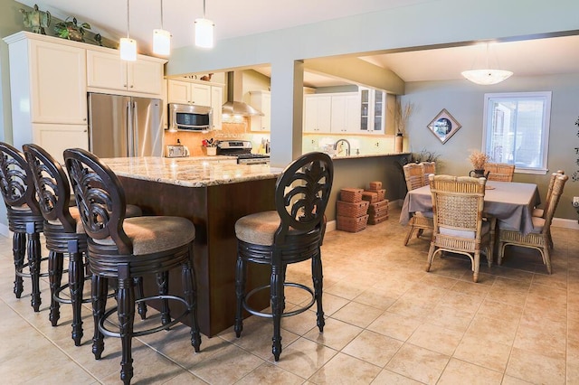 124 Collette Rd, Holden, ME 04429 - kitchen with stainless steel appliances, wall chimney range hood, light tile patterned flooring, and light stone counters